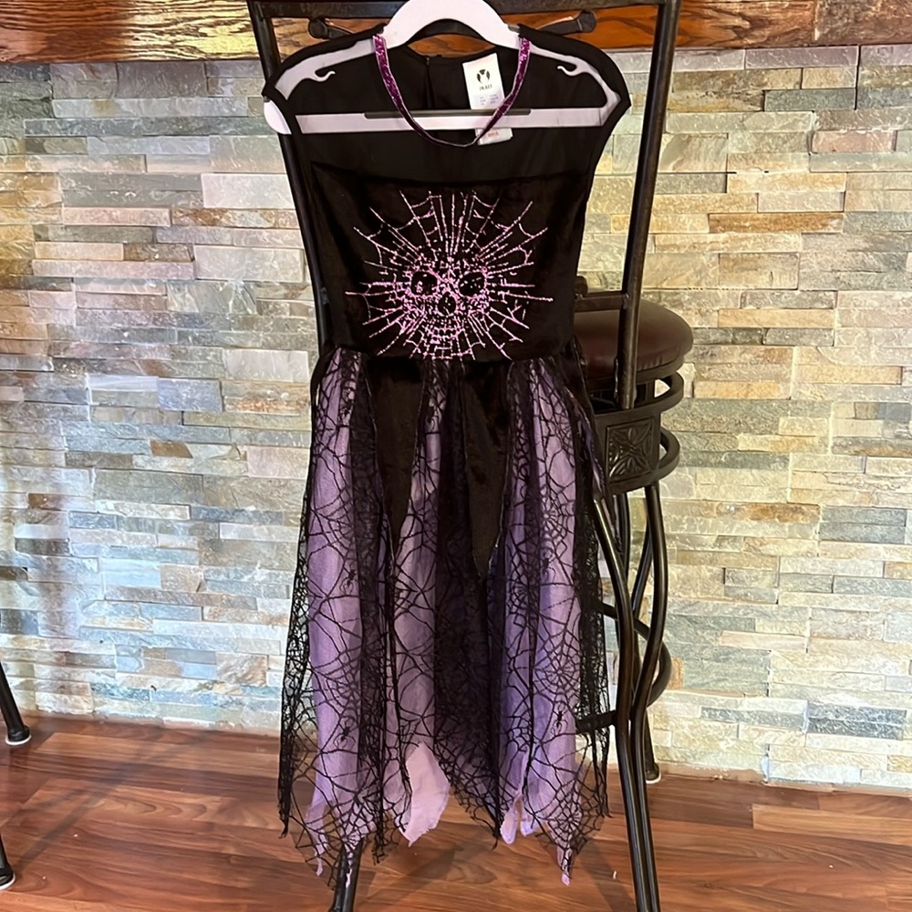 Girls size 4-6 purple and black witch costume with jagged edges webs and skull